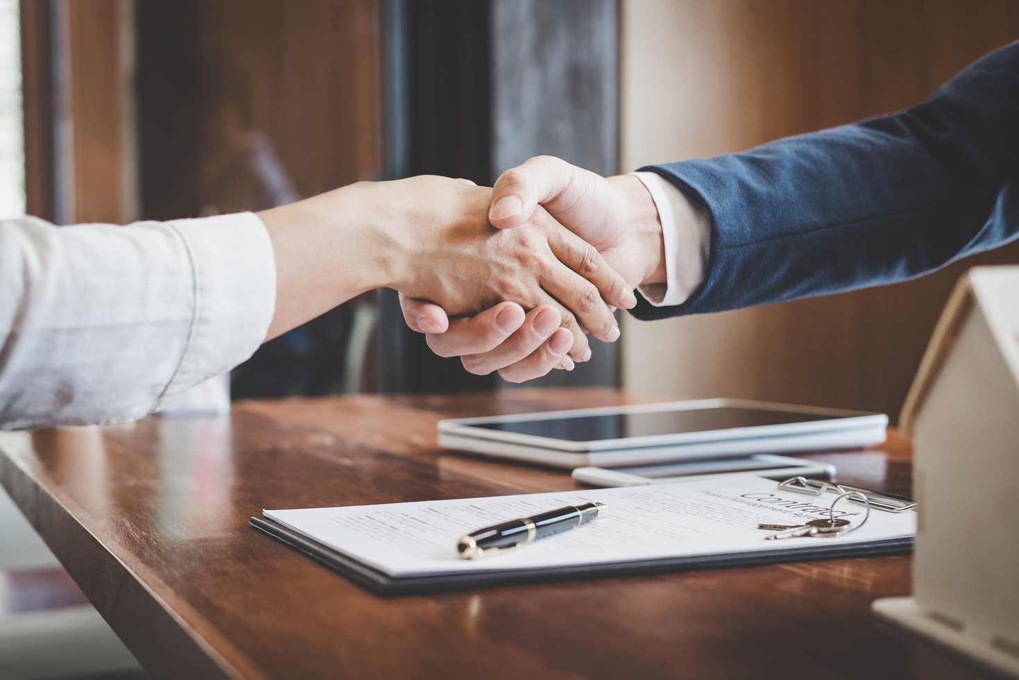 Real Estate Agent and Customers Shaking Hands